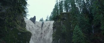 Movie still from “War for the Planet of the Apes” (2017), directed by Matt Reeves – A large waterfall is pouring over a cliff; Extreme Wide shot, Low angle