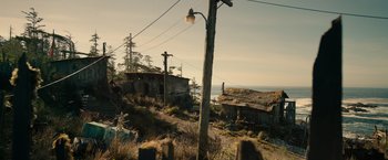Movie still from “War for the Planet of the Apes” (2017), directed by Matt Reeves – An old house on the side of a hill with power lines overhead; Extreme Wide shot, High angle