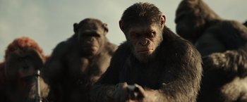 Movie still from “War for the Planet of the Apes” (2017), directed by Matt Reeves – A couple of monkeys are standing next to each other; Medium shot, Low angle