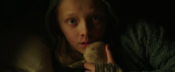 Movie still from “War for the Planet of the Apes” (2017), directed by Matt Reeves – A young girl holding a stuffed animal in her hands; Close Up shot, Low angle