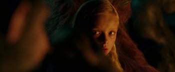 Movie still from “War for the Planet of the Apes” (2017), directed by Matt Reeves – A young blonde girl is looking at the camera; Close Up shot, Over the shoulder angle