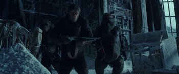 Movie still from “War for the Planet of the Apes” (2017), directed by Matt Reeves – A couple of people that are holding guns; Medium shot, Low angle