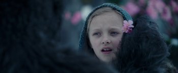 Movie still from “War for the Planet of the Apes” (2017), directed by Matt Reeves – A little girl wearing a blue hat with a flower in her hair; Close Up shot, Over the shoulder angle