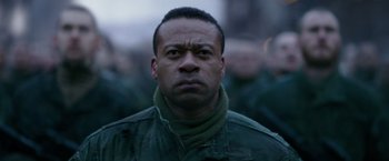 Movie still from “War for the Planet of the Apes” (2017), directed by Matt Reeves – A person wearing a green jacket; Close Up shot, Over the shoulder angle