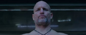 Movie still from “War for the Planet of the Apes” (2017), directed by Matt Reeves – A man with a beard and a necklace is looking at the camera; Close Up shot, Low angle