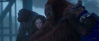 Movie still from “War for the Planet of the Apes” (2017), directed by Matt Reeves – A young girl and an animal in a dark room; Medium shot, Low angle
