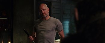 Movie still from “War for the Planet of the Apes” (2017), directed by Matt Reeves – A man with a shaved head and a beard; Medium shot, Over the shoulder angle