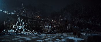 Movie still from “War for the Planet of the Apes” (2017), directed by Matt Reeves – A group of people standing in a field at night; Extreme Wide shot, High angle