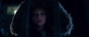 Movie still from “War for the Planet of the Apes” (2017), directed by Matt Reeves – A young child wearing a fur coat and a hood; Close Up shot, Low angle