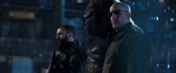 Movie still from “War for the Planet of the Apes” (2017), directed by Matt Reeves – A man with a gorilla mask and a man with a beard; Medium shot, Low angle