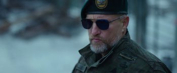 Movie still from “War for the Planet of the Apes” (2017), directed by Matt Reeves – A person wearing a hat and sunglasses; Close Up shot, Low angle