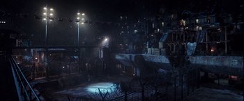 Movie still from “War for the Planet of the Apes” (2017), directed by Matt Reeves – A dark night with a lot of lights on; Extreme Wide shot, High angle