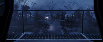 Movie still from “War for the Planet of the Apes” (2017), directed by Matt Reeves – A view of a city at night from a balcony; Extreme Wide shot, High angle