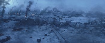 Movie still from “War for the Planet of the Apes” (2017), directed by Matt Reeves – A train traveling down train tracks through a snowy field; Extreme Wide shot, High angle