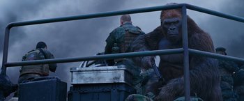 Movie still from “War for the Planet of the Apes” (2017), directed by Matt Reeves – A group of men standing next to each other on top of a truck; Medium shot, Over the shoulder angle