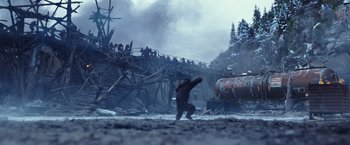 Movie still from “War for the Planet of the Apes” (2017), directed by Matt Reeves – A man in a gorilla suit running across a bridge; Extreme Wide shot, Low angle