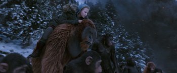 Movie still from “War for the Planet of the Apes” (2017), directed by Matt Reeves – A group of people riding on the back of a gorilla; Medium shot, Low angle