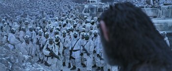 Movie still from “War for the Planet of the Apes” (2017), directed by Matt Reeves – A group of people in white suits and masks; Wide shot, High angle