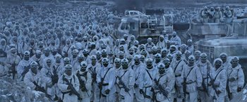 Movie still from “War for the Planet of the Apes” (2017), directed by Matt Reeves – A large group of people in white suits and helmets; Wide shot, High angle