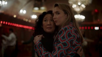 Movie still from “Killing Eve” (2018), created by Phoebe Waller-Bridge – Two women embracing each other in a room; Medium shot, Low angle