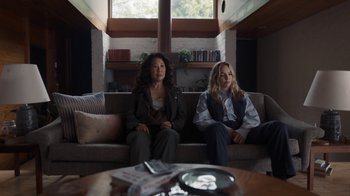 Movie still from “Killing Eve” (2018), created by Phoebe Waller-Bridge – Two women sitting on a couch in front of a window; Wide shot, High angle
