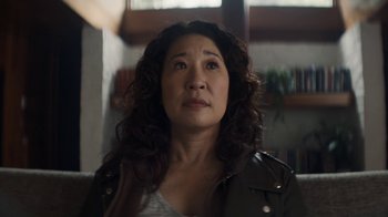 Movie still from “Killing Eve” (2018), created by Phoebe Waller-Bridge – An older woman with curly brown hair looking at the camera; Close Up shot, Over the shoulder angle