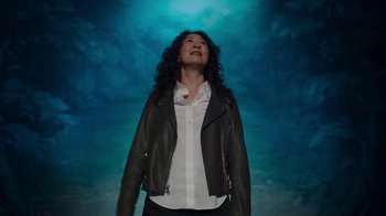 Movie still from “Killing Eve” (2018), created by Phoebe Waller-Bridge – A woman wearing a leather jacket looking up at the sky; Medium shot, High angle