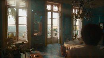 Movie still from “Killing Eve” (2018), created by Phoebe Waller-Bridge – A room filled with furniture next to a large window; Extreme Wide shot, High angle