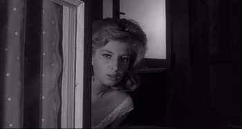 Movie still from “L'Eclisse” (1962), directed by Michelangelo Antonioni – A black - and - white photo of a woman looking out of a window; Close Up shot, Low angle