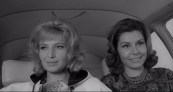 Movie still from “L'Eclisse” (1962), directed by Michelangelo Antonioni – A black and white photo of two women in a car; Close Up shot, Low angle