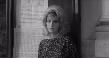 Movie still from “L'Eclisse” (1962), directed by Michelangelo Antonioni – A black and white photo of a woman in front of a wall; Close Up shot, Low angle