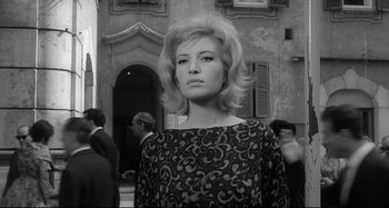 Movie still from “L'Eclisse” (1962), directed by Michelangelo Antonioni – A black and white photo of a woman in a dress; Close Up shot, Low angle