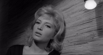Movie still from “L'Eclisse” (1962), directed by Michelangelo Antonioni – A black and white photo of a woman's face; Close Up shot, High angle