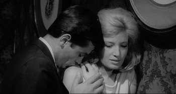 Movie still from “L'Eclisse” (1962), directed by Michelangelo Antonioni – A man and a woman are holding a baby; Close Up shot, Low angle