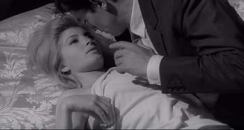 Movie still from “L'Eclisse” (1962), directed by Michelangelo Antonioni – A man and a woman in a white shirt; Close Up shot, High angle