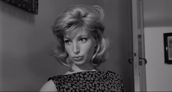 Movie still from “L'Eclisse” (1962), directed by Michelangelo Antonioni – A black and white photo of a woman in a dress; Close Up shot, Low angle