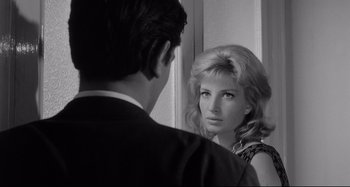 Movie still from “L'Eclisse” (1962), directed by Michelangelo Antonioni – A man and a woman looking at one another in a mirror; Close Up shot, Over the shoulder angle