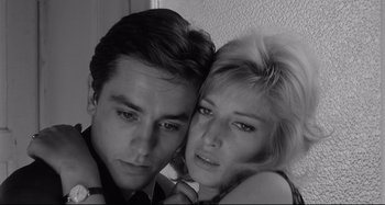 Movie still from “L'Eclisse” (1962), directed by Michelangelo Antonioni – A man and a woman pose for a picture; Close Up shot, Low angle