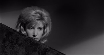 Movie still from “L'Eclisse” (1962), directed by Michelangelo Antonioni – A black and white photo of a woman with her head leaning on a wall; Close Up shot, Low angle