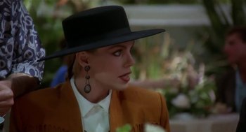 Movie still from “L.A. Story” (1991), directed by Mick Jackson – A person wearing a hat; Close Up shot, Over the shoulder angle