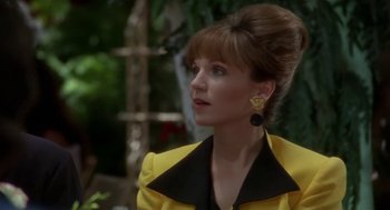 Movie still from “L.A. Story” (1991), directed by Mick Jackson – A person wearing a yellow jacket; Close Up shot, Over the shoulder angle