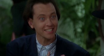 Movie still from “L.A. Story” (1991), directed by Mick Jackson – A person wearing a suit and tie; Close Up shot, Low angle