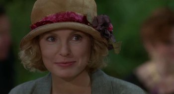 Movie still from “L.A. Story” (1991), directed by Mick Jackson – A person wearing a hat with flowers on it; Close Up shot, Over the shoulder angle