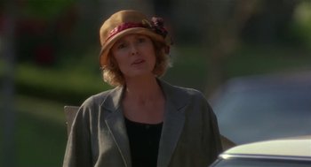 Movie still from “L.A. Story” (1991), directed by Mick Jackson – A woman wearing a hat and a jacket; Close Up shot, Over the shoulder angle