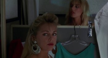 Movie still from “L.A. Story” (1991), directed by Mick Jackson – A woman in a blue shirt is looking in the mirror; Close Up shot, Over the shoulder angle