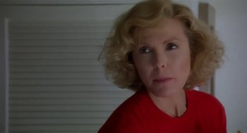 Movie still from “L.A. Story” (1991), directed by Mick Jackson – A person wearing a red t - shirt; Close Up shot, Low angle