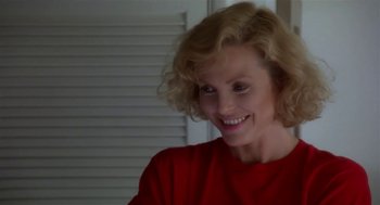 Movie still from “L.A. Story” (1991), directed by Mick Jackson – A person wearing a red shirt; Close Up shot, Over the shoulder angle