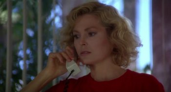 Movie still from “L.A. Story” (1991), directed by Mick Jackson – A woman talking on a phone while wearing a red shirt; Close Up shot, Low angle