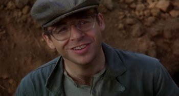 Movie still from “L.A. Story” (1991), directed by Mick Jackson – A person wearing glasses and a hat; Close Up shot, Over the shoulder angle