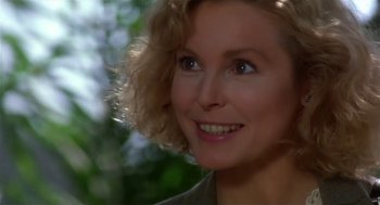 Movie still from “L.A. Story” (1991), directed by Mick Jackson – A woman smiling for the camera; Close Up shot, Over the shoulder angle